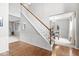 Elegant staircase featuring wood and white trim, leading to the upper level at 14353 Chariots Whisper Dr, Carmel, IN 46074