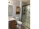 Clean bathroom with a marble-tiled shower, updated vanity, and modern fixtures at 1562 Prairieview Ln, Greenfield, IN 46140