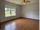 Bright bedroom with hardwood floors and a large window offering natural light at 1562 Prairieview Ln, Greenfield, IN 46140