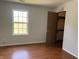 Bedroom featuring hardwood floors, a bright window, and a closet perfect for storage at 1562 Prairieview Ln, Greenfield, IN 46140
