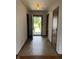 Bright foyer featuring tile flooring and view to landscaped front yard through an open front door at 1562 Prairieview Ln, Greenfield, IN 46140