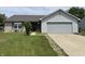 Charming single-story home with gray siding, brick accents, and a well-manicured lawn at 1562 Prairieview Ln, Greenfield, IN 46140