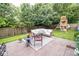 Outdoor patio features a seating area, lush landscaping, and a playset in the backyard at 17841 Grassy Knoll Dr, Westfield, IN 46074