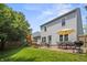 Spacious backyard with a patio, outdoor seating, lush lawn, and play area, perfect for Gathering enjoyment at 17841 Grassy Knoll Dr, Westfield, IN 46074