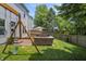 Beautifully landscaped backyard featuring a swing set, patio furniture, and well-maintained lawn at 17841 Grassy Knoll Dr, Westfield, IN 46074