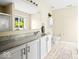 Bright bathroom featuring a spacious vanity with double sinks, white cabinets, and a large mirror reflecting natural light at 17841 Grassy Knoll Dr, Westfield, IN 46074