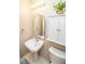 Modern half bath with a pedestal sink, large mirror and storage cabinet at 17841 Grassy Knoll Dr, Westfield, IN 46074