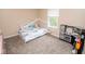 Neutral bedroom with a play kitchen, window, plush carpet and a cute, comfy bed at 17841 Grassy Knoll Dr, Westfield, IN 46074