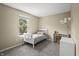 Cozy bedroom with a white bed frame, plush gray carpeting, and a bright window at 17841 Grassy Knoll Dr, Westfield, IN 46074