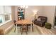 Cozy dining room with a wooden table, seating for four, and a large window providing natural light at 17841 Grassy Knoll Dr, Westfield, IN 46074