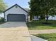 Charming home featuring a spacious driveway, well-manicured lawn, and beautiful landscaping at 17841 Grassy Knoll Dr, Westfield, IN 46074