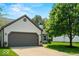 Charming home exterior with a two-car garage, well-maintained lawn, mature tree, and inviting curb appeal at 17841 Grassy Knoll Dr, Westfield, IN 46074