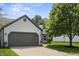 Attractive home featuring a grey two-car garage, charming details, and mature trees on a sunny day at 17841 Grassy Knoll Dr, Westfield, IN 46074