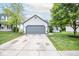 Charming one-story home with a two-car garage, a well-manicured lawn, and mature shade trees at 17841 Grassy Knoll Dr, Westfield, IN 46074
