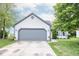 Exterior showcasing a home with a gray garage door, manicured lawn and landscaping at 17841 Grassy Knoll Dr, Westfield, IN 46074