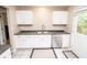 Kitchen featuring a stainless steel sink, white cabinetry, and a view to the backyard at 17841 Grassy Knoll Dr, Westfield, IN 46074