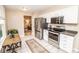 Well-lit kitchen features stainless steel appliances, white cabinets, and tiled floor at 17841 Grassy Knoll Dr, Westfield, IN 46074