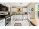 Well-lit kitchen with stainless steel appliances, sleek white cabinets, and modern countertops at 17841 Grassy Knoll Dr, Westfield, IN 46074