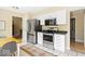 Eat-in kitchen features stainless steel appliances, white cabinetry, and a view to the breakfast area at 17841 Grassy Knoll Dr, Westfield, IN 46074