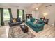 Inviting living room with large windows, wood floors, and comfortable seating for entertaining guests at 17841 Grassy Knoll Dr, Westfield, IN 46074