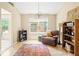 Relaxing living room space with natural light, comfortable seating, and hardwood floors at 17841 Grassy Knoll Dr, Westfield, IN 46074
