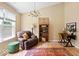Relaxing living room space with natural light, comfortable seating, and a wooden desk at 17841 Grassy Knoll Dr, Westfield, IN 46074