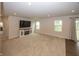 Open-concept living room with plush carpeting, fireplace, and ample natural light from large windows at 1863 River Birch Dr, Greenfield, IN 46140