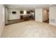 Bright open living area flowing into a modern kitchen with stainless steel appliances and a center island at 1863 River Birch Dr, Greenfield, IN 46140