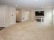 Inviting living room with plush carpeting, fireplace, and open access to the kitchen and hallway at 1863 River Birch Dr, Greenfield, IN 46140