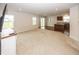 Spacious living room seamlessly connecting to the kitchen, featuring carpet and hardwood floors at 1863 River Birch Dr, Greenfield, IN 46140