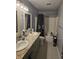 Bathroom featuring double sinks, granite countertops, and a shower-tub combo at 2248 Salem Park Dr, Indianapolis, IN 46239