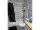 Bright bathroom with marble tile, black accents, and tub shower combo at 2248 Salem Park Dr, Indianapolis, IN 46239