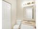 Bathroom featuring a vanity with a sink, a mirror with lights, and a toilet at 2306 Brightwell Pl, Indianapolis, IN 46260