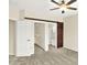 Bedroom features standard closet, a barn door and a ceiling fan at 2306 Brightwell Pl, Indianapolis, IN 46260