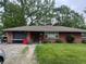 Charming brick ranch-style home with mature trees and a well-maintained front lawn at 2330 Ridgewood Dr, Anderson, IN 46012