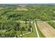 Expansive aerial view of the property with mature trees, road frontage, and cultivated fields in the surrounding landscape at 2346 N State Road 39, Danville, IN 46122