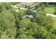 Aerial view of a home nestled among lush greenery and neighboring farmland with road access at 2346 N State Road 39, Danville, IN 46122