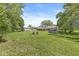Expansive backyard view with a detached garage, trampoline, fire pit, and ample space for outdoor activities at 2346 N State Road 39, Danville, IN 46122