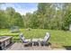 Enjoy outdoor living on the patio with comfortable seating, a trampoline, and a fire pit in the spacious backyard at 2346 N State Road 39, Danville, IN 46122