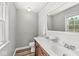 Bathroom with double sinks, a wooden vanity and shiplap walls at 2346 N State Road 39, Danville, IN 46122