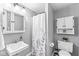 Well-lit bathroom features a shower, storage cabinet, and a pedestal sink at 2346 N State Road 39, Danville, IN 46122