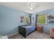 Cozy bedroom with blue walls, carpeted floor, and abundant natural light from two windows at 2346 N State Road 39, Danville, IN 46122
