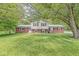 Charming brick home featuring a well-maintained lawn, mature trees, and classic architectural details at 2346 N State Road 39, Danville, IN 46122