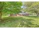 Charming home featuring a lush green lawn, mature trees, and a welcoming facade, creating a serene and inviting atmosphere at 2346 N State Road 39, Danville, IN 46122