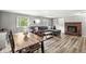 Comfortable living room area features wood paneling, hardwood floors, a fireplace, and an open dining space at 2346 N State Road 39, Danville, IN 46122