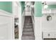 Bright stairwell with carpeted stairs and white wood paneling at 2346 N State Road 39, Danville, IN 46122