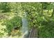 Picturesque stream with clear water flowing gently under a canopy of green trees and vegetation at 2346 N State Road 39, Danville, IN 46122