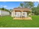Backyard view of pergola with table and chairs on wood deck with view of the light siding house at 2414 N Blaine St, Muncie, IN 47303