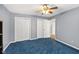 This bedroom features plush blue carpeting, multiple closets, and neutral paint at 2414 N Blaine St, Muncie, IN 47303