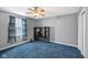 Bedroom featuring blue carpet, a ceiling fan and natural light at 2414 N Blaine St, Muncie, IN 47303